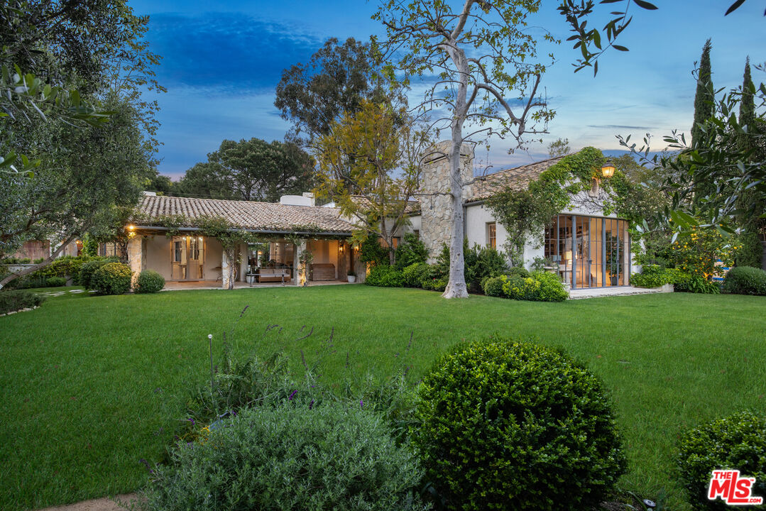13233 Riviera Ranch Road Los Angeles, CA 90049 - Photo 1 of 1 a view of a big yard with a large tree