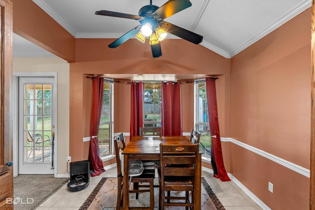 122 Ragan Lane Haughton, LA 71037 - Photo 15 of 34 Bay window with multiple panes, ceiling fan light fixture, tile flooring, and crown molding