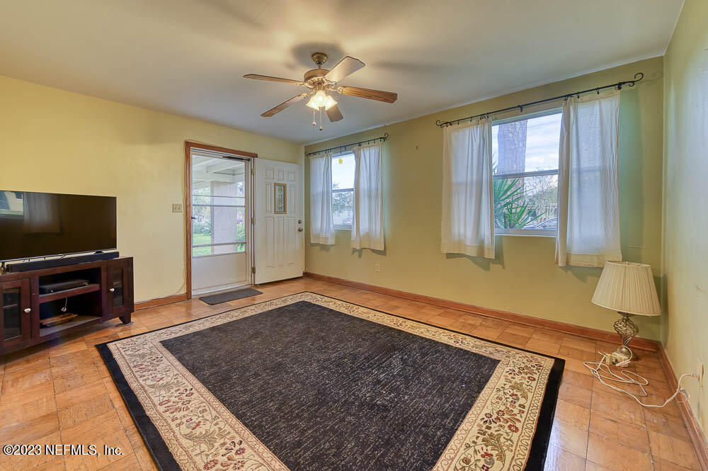 5214 Batley Road Jacksonville, FL 32210 - Photo 4 of 16 a living room with furniture and a flat screen tv