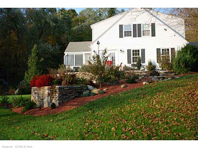 a front view of a house with a yard and lake view