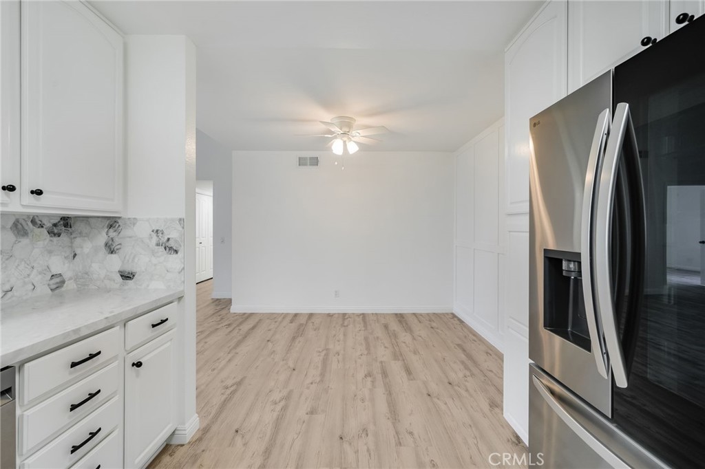 34112 Selva Road, Unit 329 Dana Point, CA 92629 - Photo 13 of 34 a view of cabinets with wooden floor and electronic appliances
