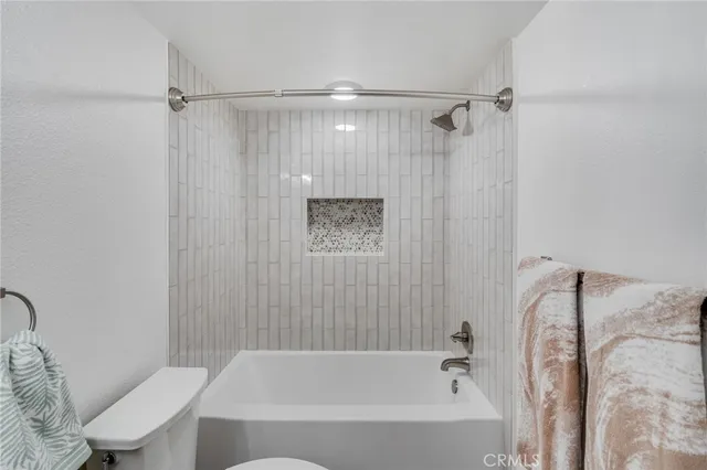 a bathroom with a bathtub toilet and shower