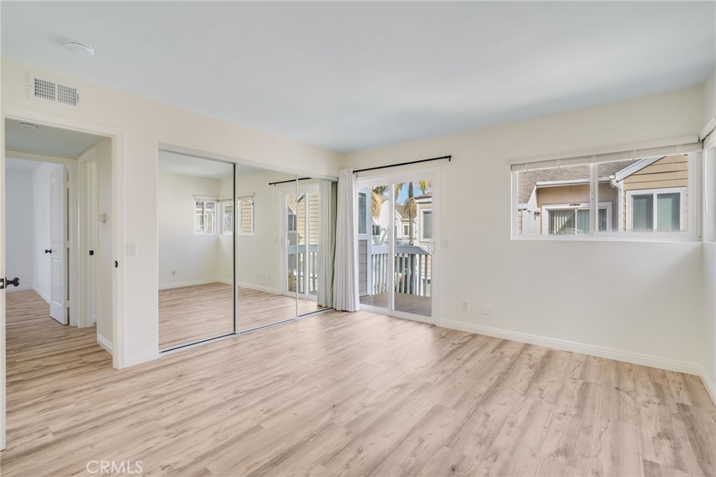 34112 Selva Road, Unit 329 Dana Point, CA 92629 - Photo 21 of 34 a view of an empty room with wooden floor and a window