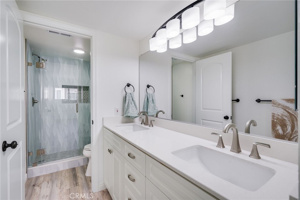 34112 Selva Road, Unit 329 Dana Point, CA 92629 - Photo 23 of 34 a bathroom with double vanity sink a toilet and a mirror