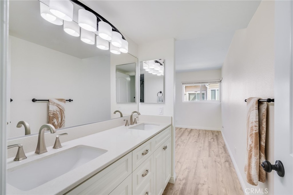 34112 Selva Road, Unit 329 Dana Point, CA 92629 - Photo 28 of 34 a bathroom with a double vanity sink and a mirror