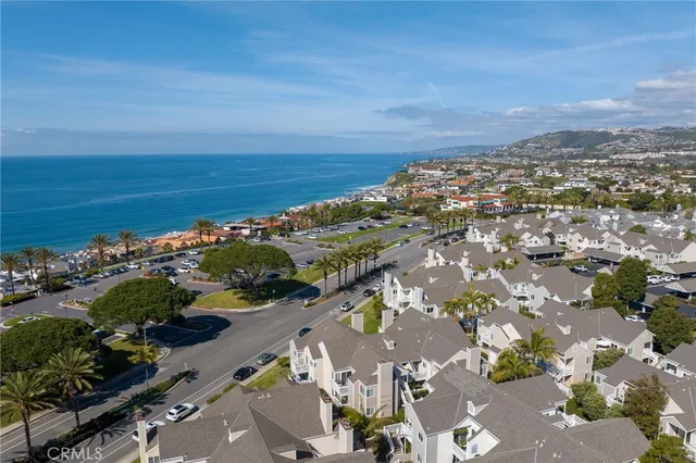an aerial view of lake and residential houses with outdoor space