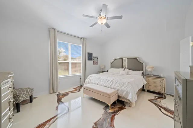 a bedroom with a bed dresser and a window