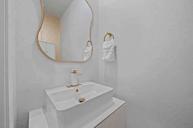 a bathroom with a sink and mirror