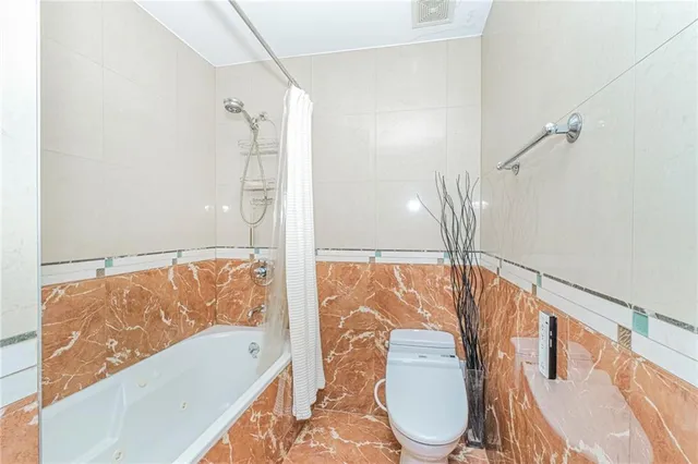 a bathroom with a bathtub and a shower