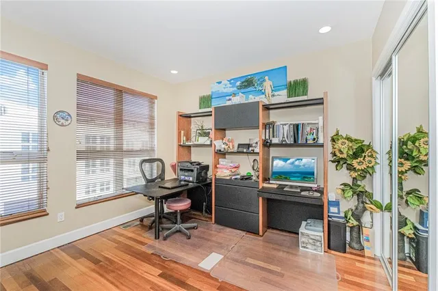 a view of a workspace with furniture and a window