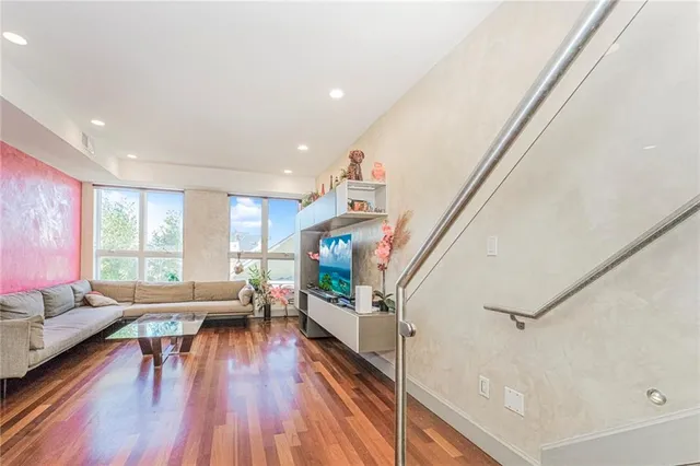 a living room with furniture and a wooden floor