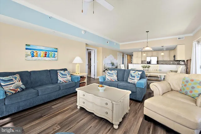 a living room with furniture and kitchen view