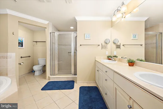 a spacious bathroom with a double vanity sink a mirror and a bathtub