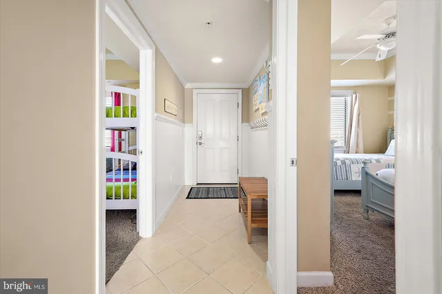 a bedroom with two beds and white cabinets