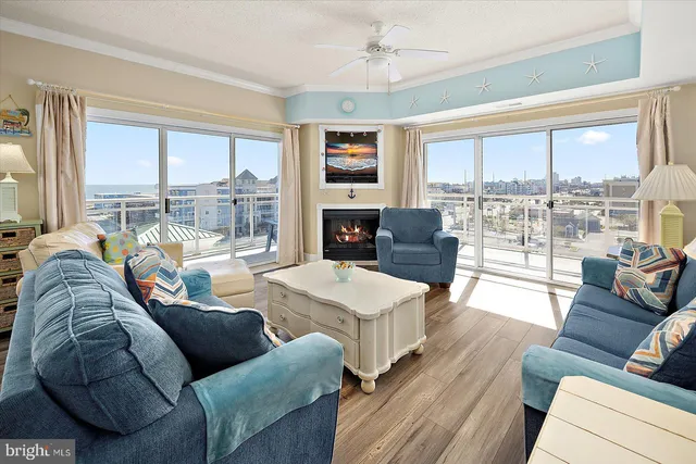 a living room with furniture large windows and a flat screen tv