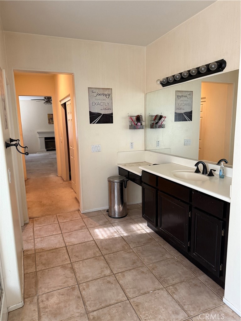 13571 Canyon Crest Way Eastvale, CA 92880 - Photo 17 of 23 a spacious bathroom with a double vanity sink a mirror and a bathtub