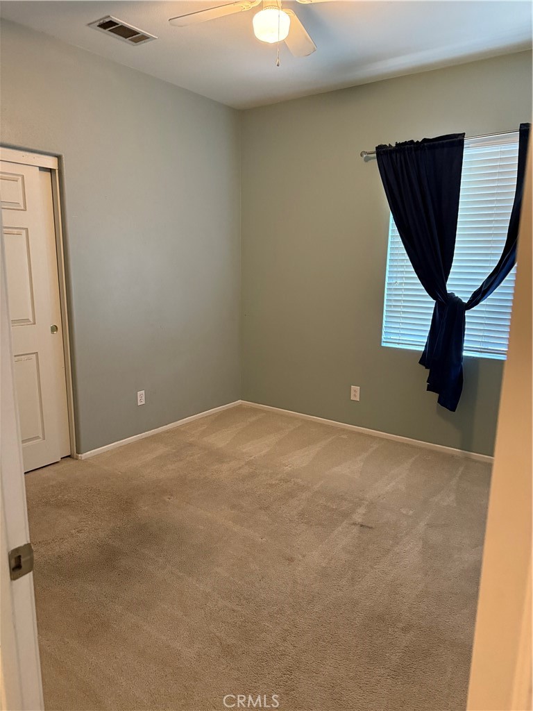 13571 Canyon Crest Way Eastvale, CA 92880 - Photo 21 of 23 an empty room with wooden floor and windows