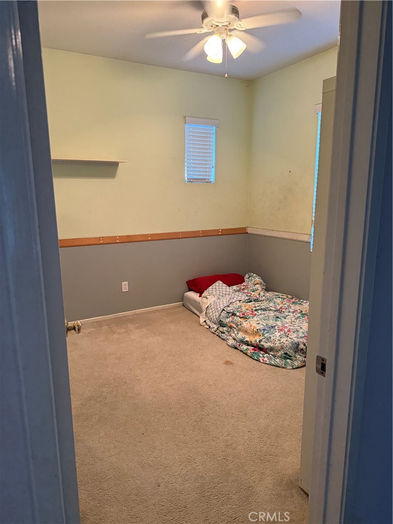 13571 Canyon Crest Way Eastvale, CA 92880 - Photo 22 of 23 a bedroom with a bed and a chandelier