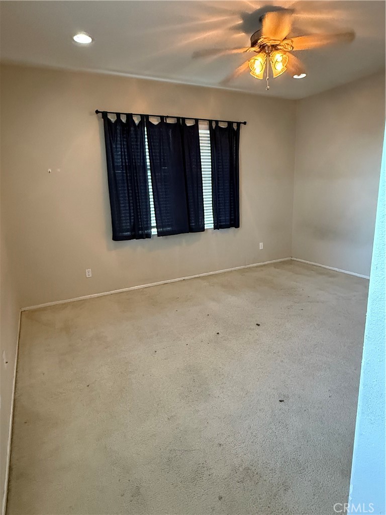 13571 Canyon Crest Way Eastvale, CA 92880 - Photo 23 of 23 a view of a room with a ceiling fan and a window