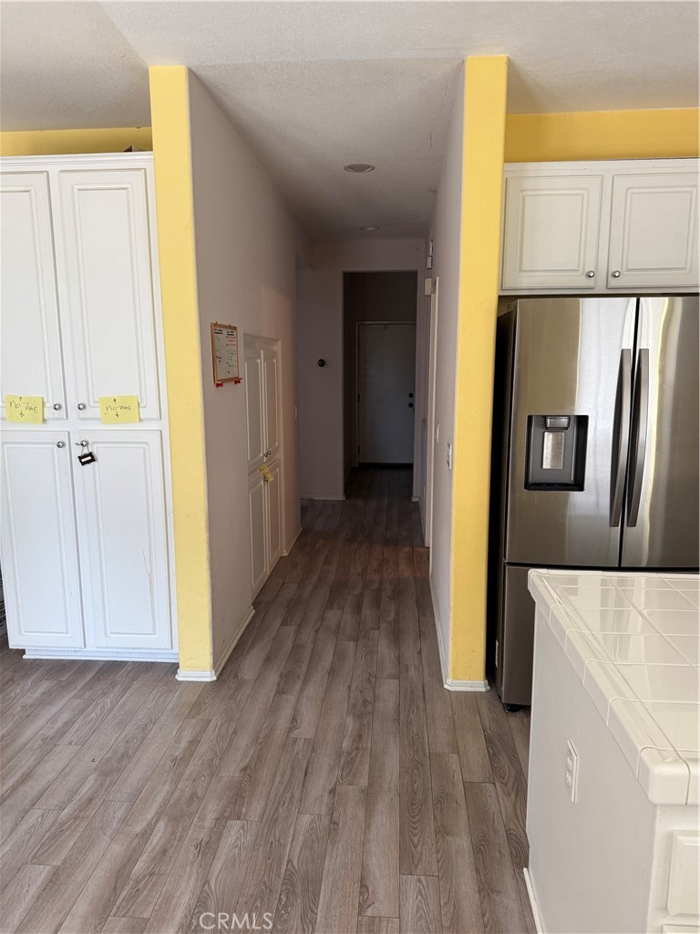 13571 Canyon Crest Way Eastvale, CA 92880 - Photo 7 of 23 a view of hallway with wooden floor