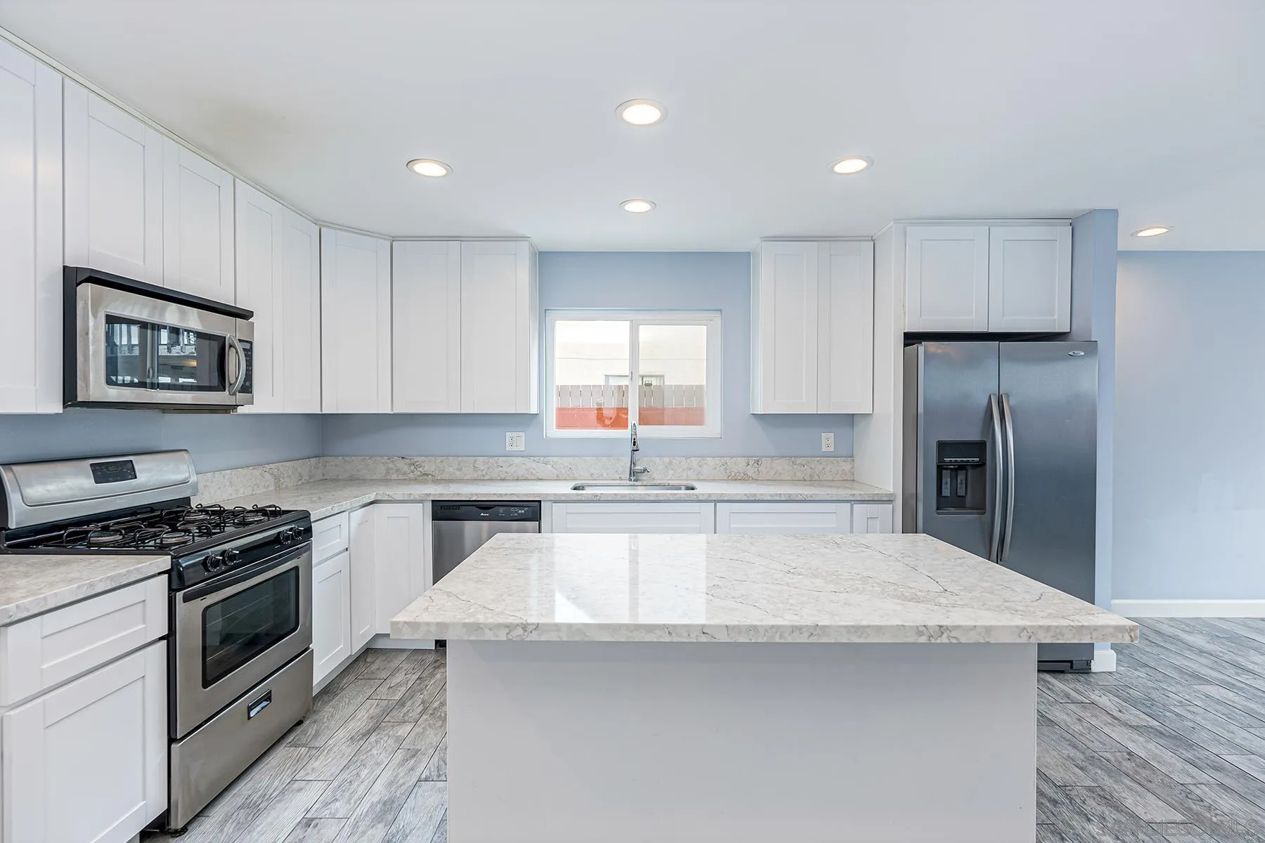 8269 Water View Court Spring Valley, CA 91977 - Photo 5 of 14 a kitchen with granite countertop a stove a sink and a refrigerator