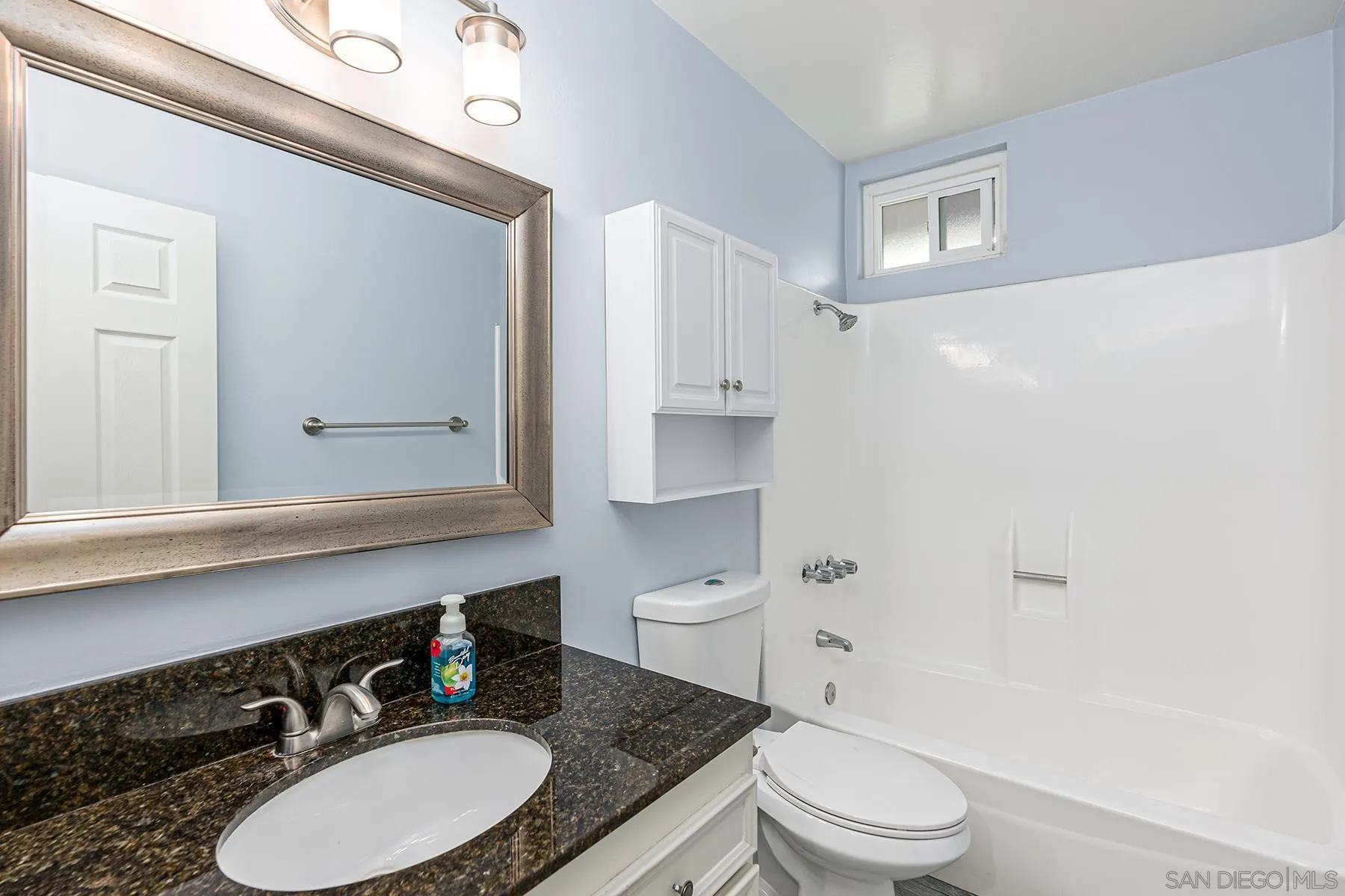 8269 Water View Court Spring Valley, CA 91977 - Photo 7 of 14 a bathroom with a granite countertop toilet a sink and a mirror