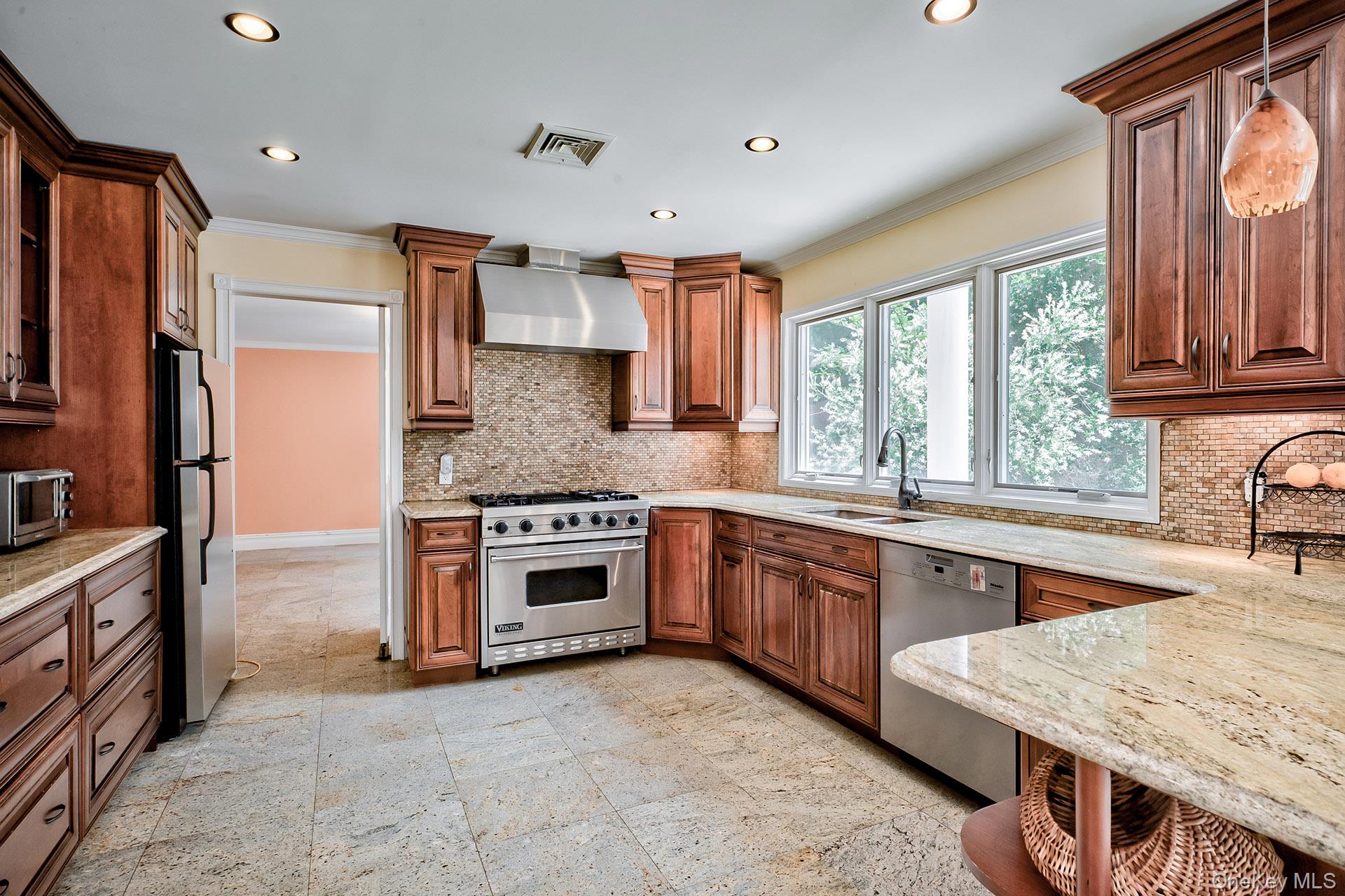 262 Harbor Acres Road Port Washington, NY 11050 - Photo 11 of 27 a kitchen with stainless steel appliances granite countertop a sink stove refrigerator granite counter tops and window