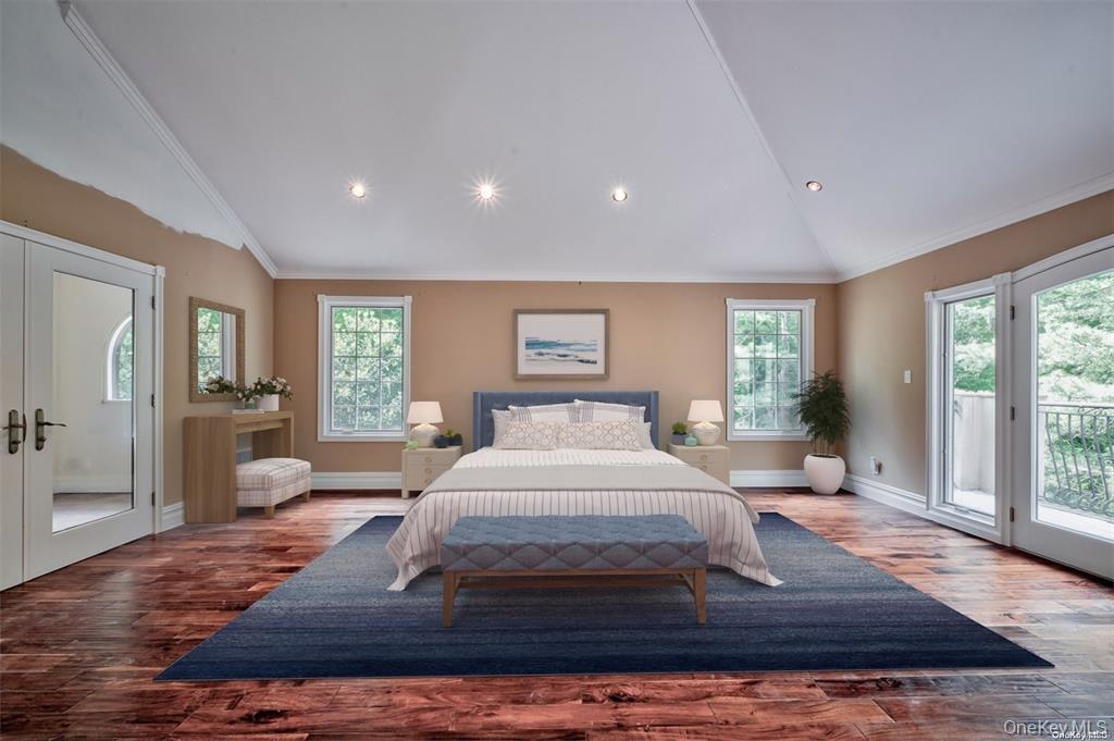 262 Harbor Acres Road Port Washington, NY 11050 - Photo 12 of 27 a bedroom with a large bed and wooden floor