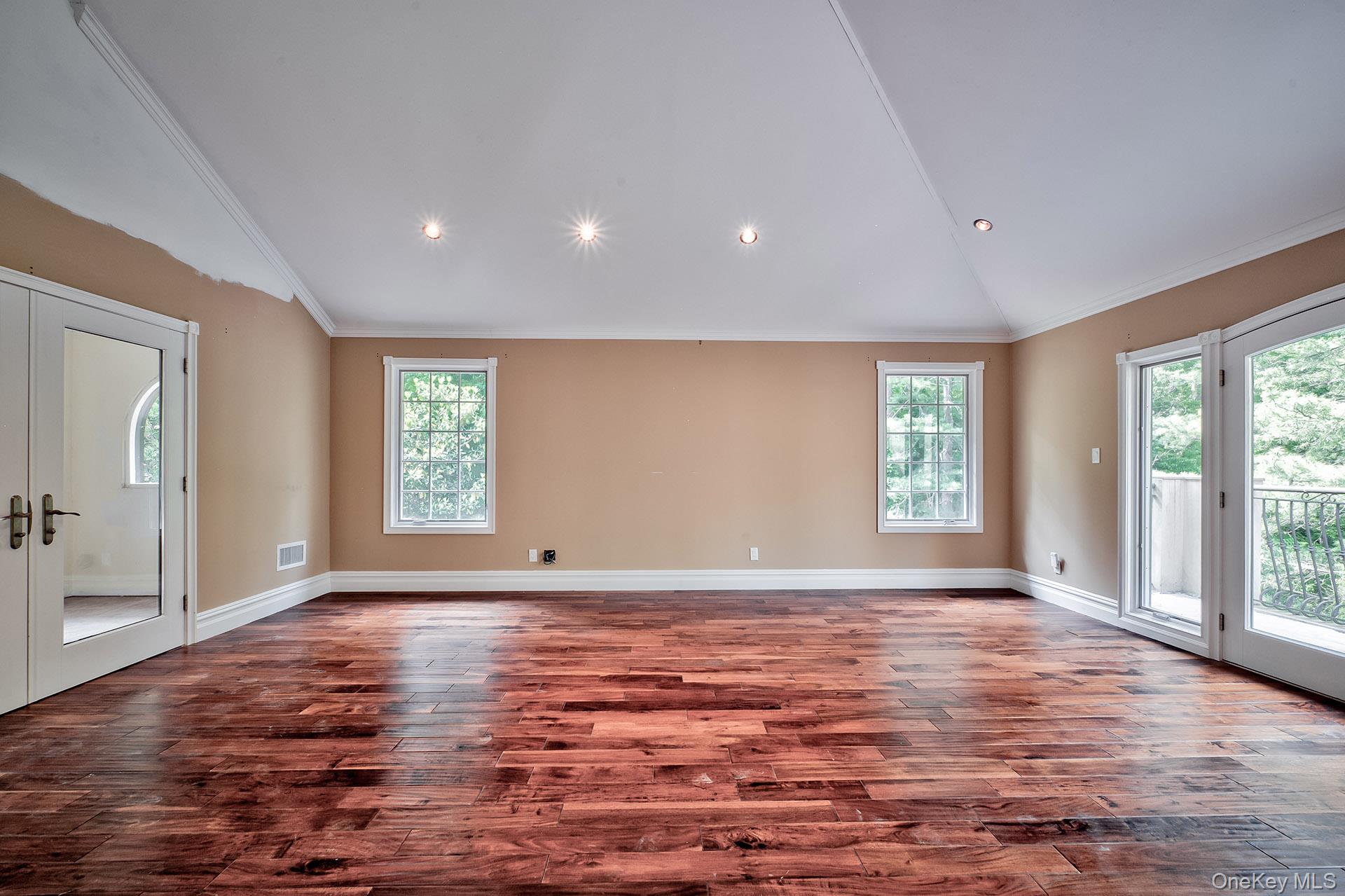 262 Harbor Acres Road Port Washington, NY 11050 - Photo 13 of 27 a view of an empty room with a window and wooden floor