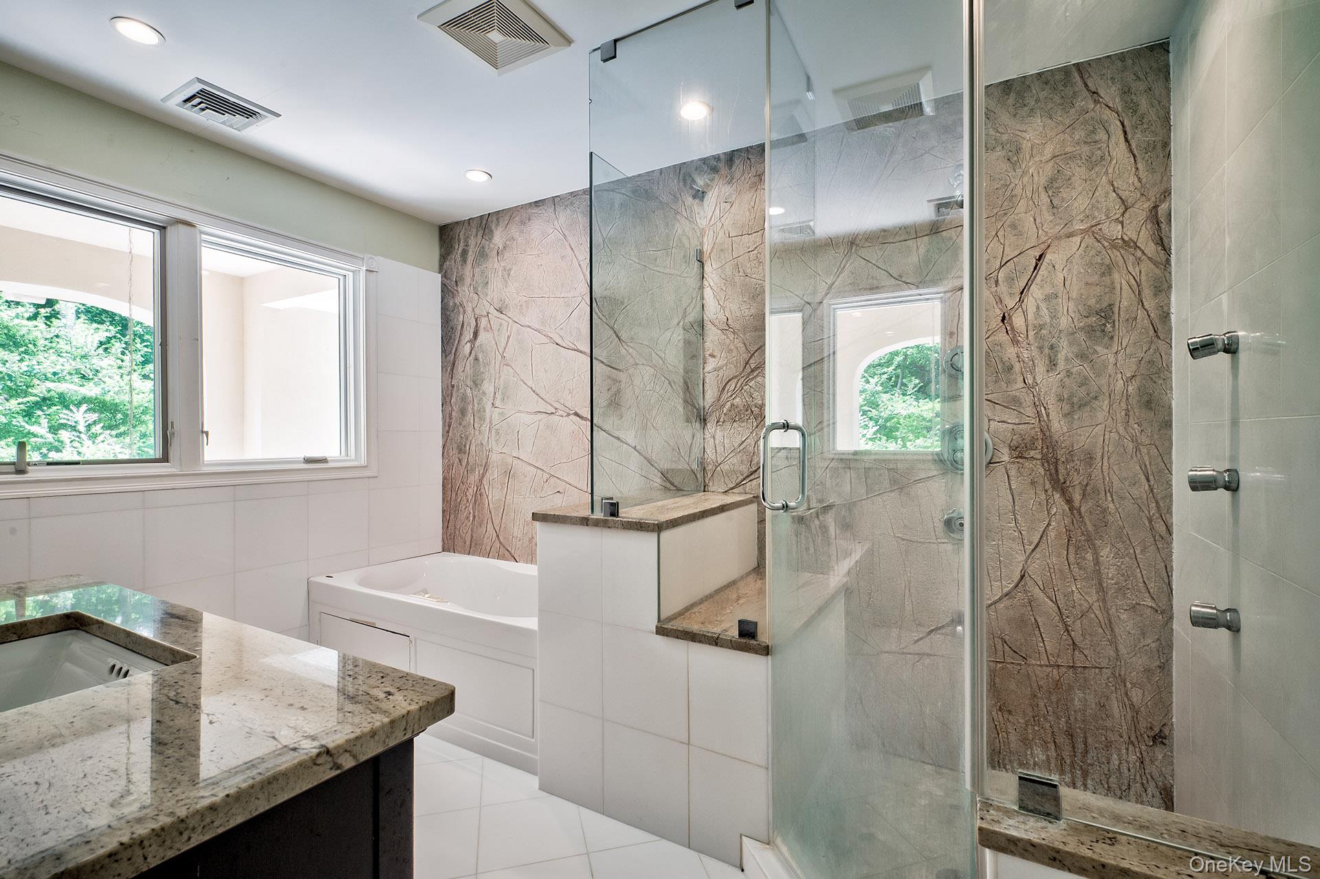 262 Harbor Acres Road Port Washington, NY 11050 - Photo 14 of 27 a bathroom with a granite countertop sink and shower