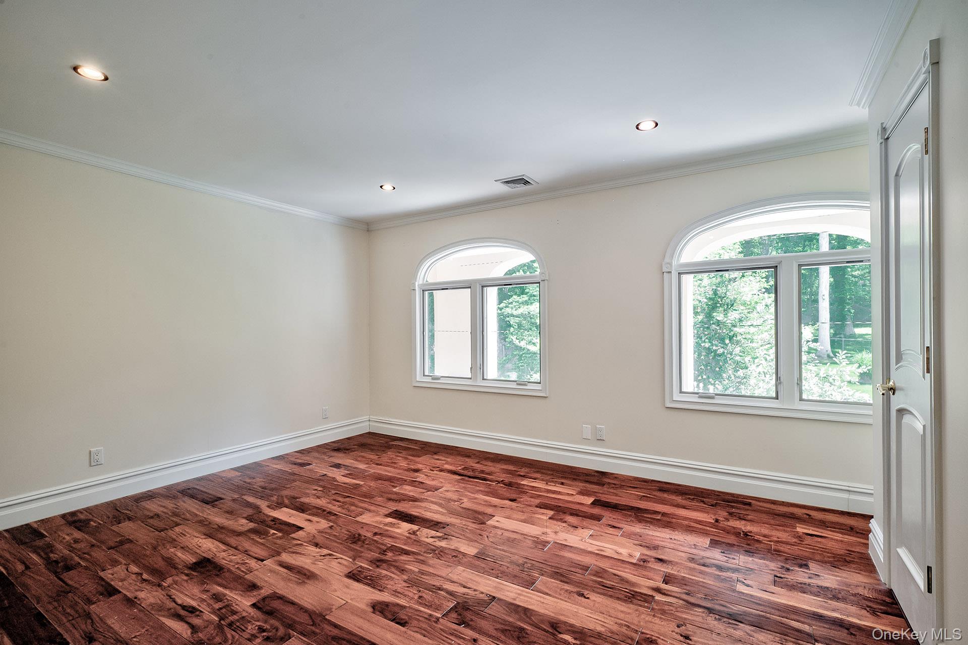 262 Harbor Acres Road Port Washington, NY 11050 - Photo 16 of 27 a view of an empty room with wooden floor and a window