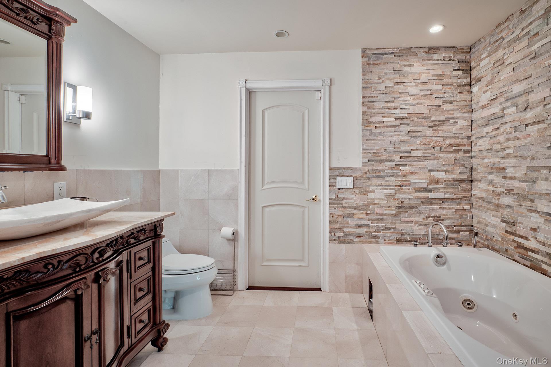 262 Harbor Acres Road Port Washington, NY 11050 - Photo 18 of 27 a bathroom with a granite countertop sink toilet and shower