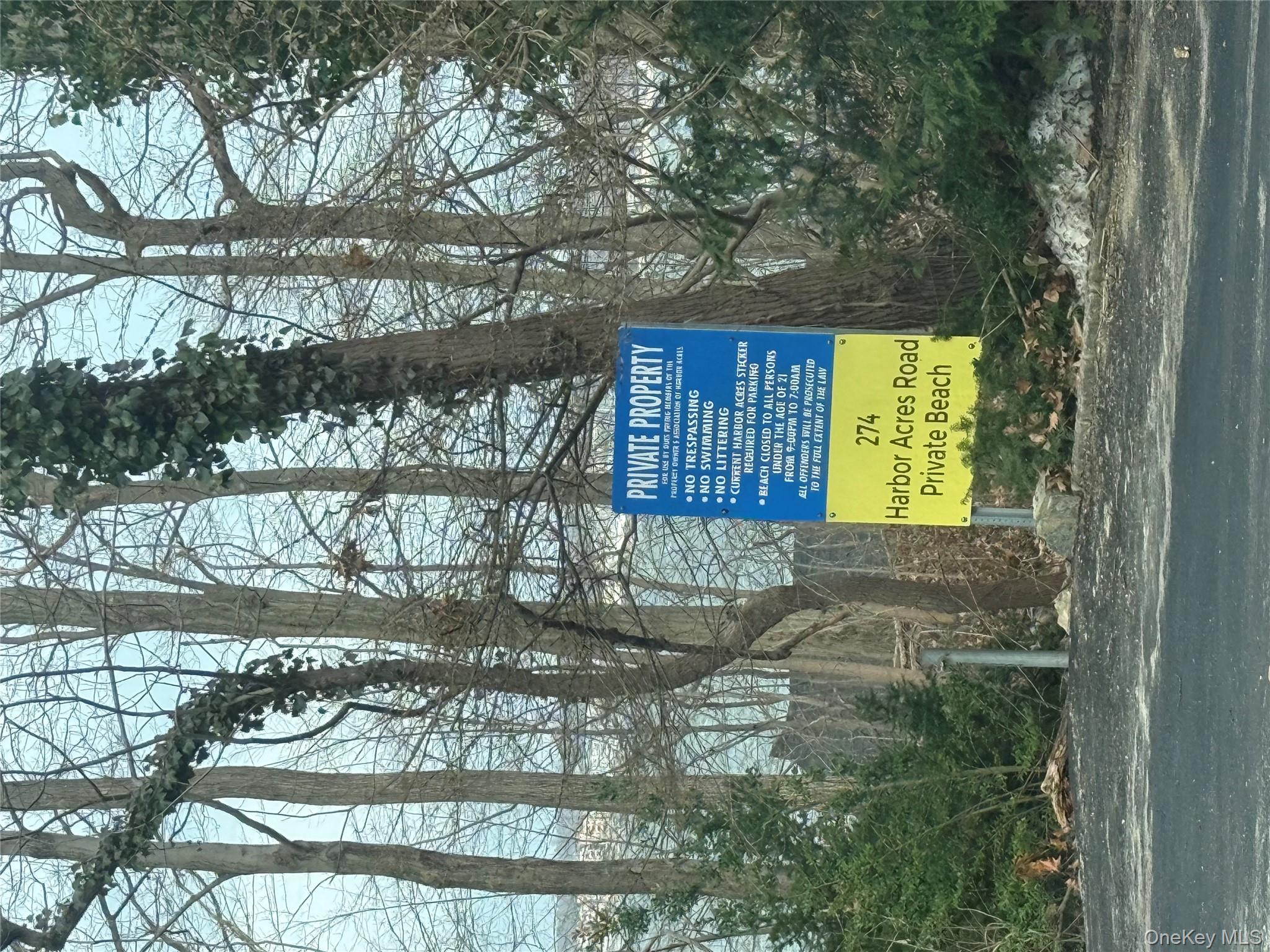 262 Harbor Acres Road Port Washington, NY 11050 - Photo 23 of 27 a sign on the side of a road