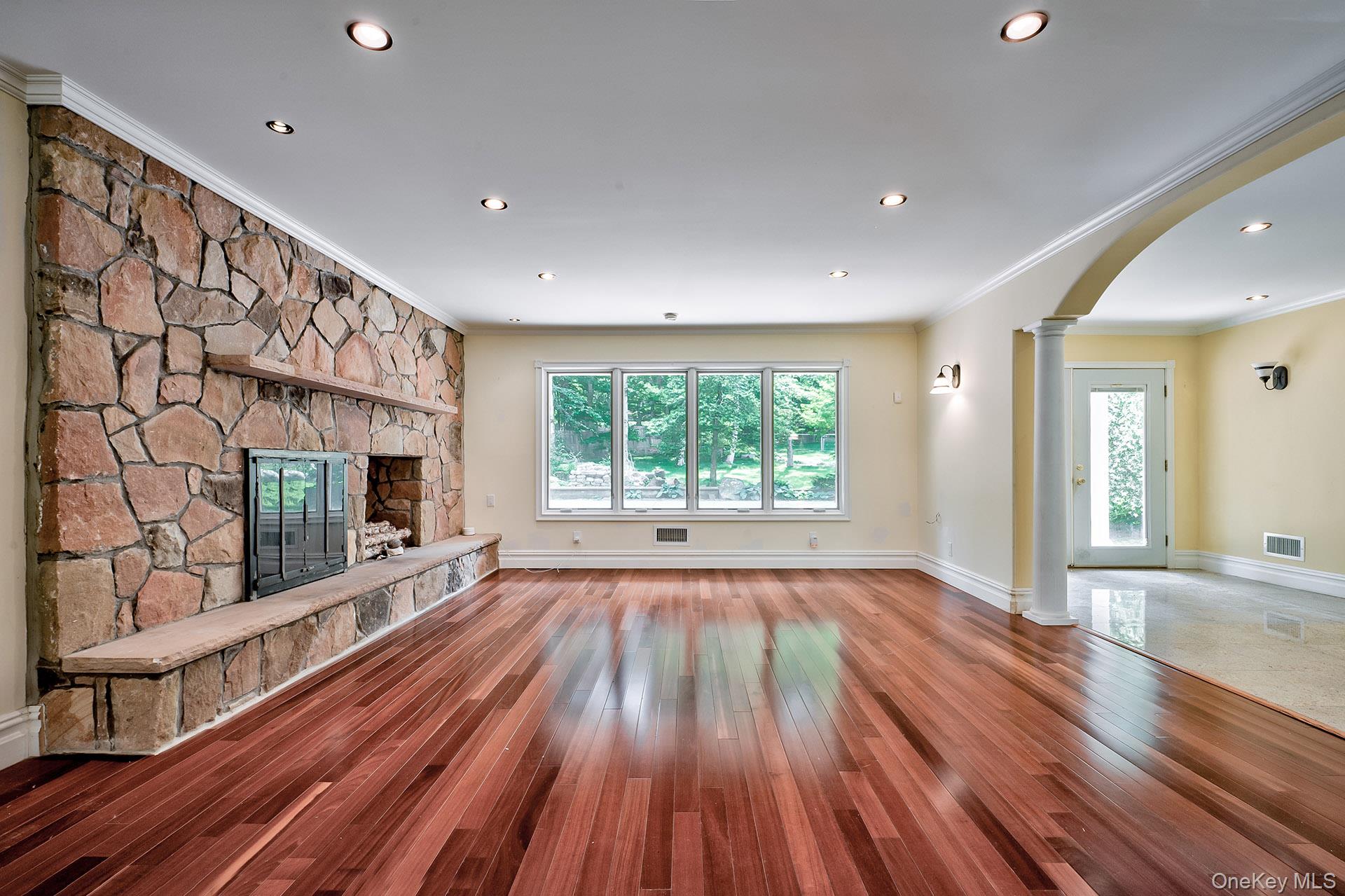262 Harbor Acres Road Port Washington, NY 11050 - Photo 7 of 27 a view of an empty room with wooden floor and a window