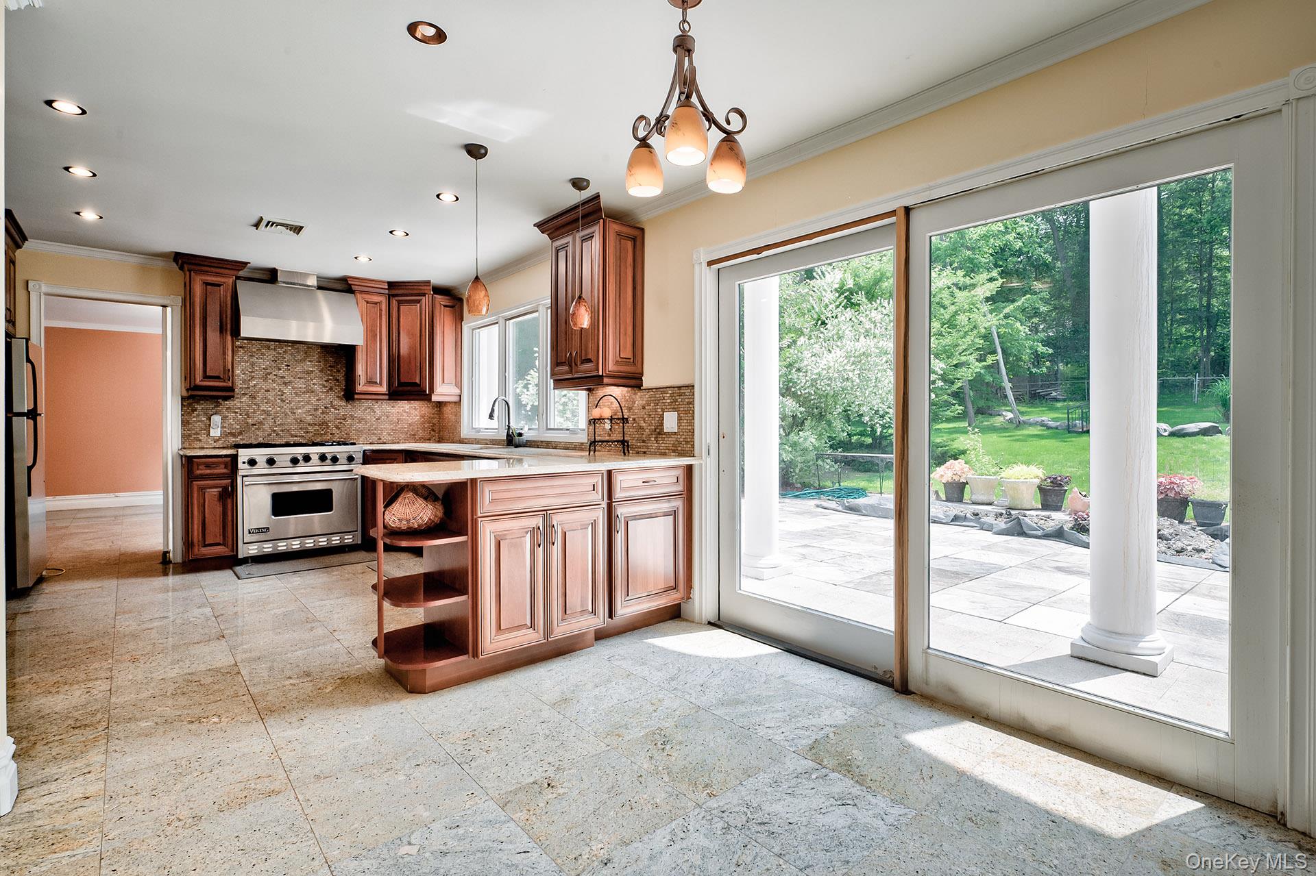 262 Harbor Acres Road Port Washington, NY 11050 - Photo 10 of 27 a large kitchen with stainless steel appliances granite countertop a stove top oven a sink and cabinets