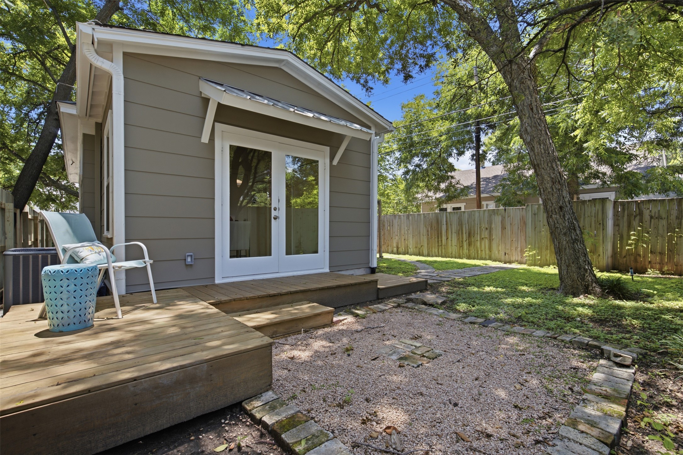 206 East 43rd Street Austin, TX 78751 - Photo 24 of 29 Cozy wood patio, offers a sitting area among the shade.