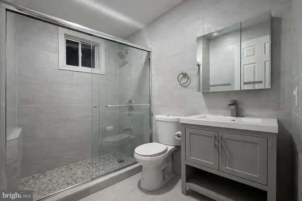 a bathroom with a toilet sink and shower