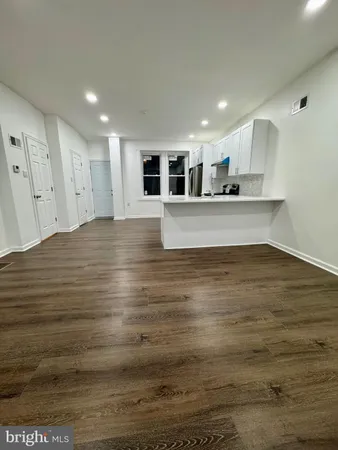 a view of kitchen and empty room