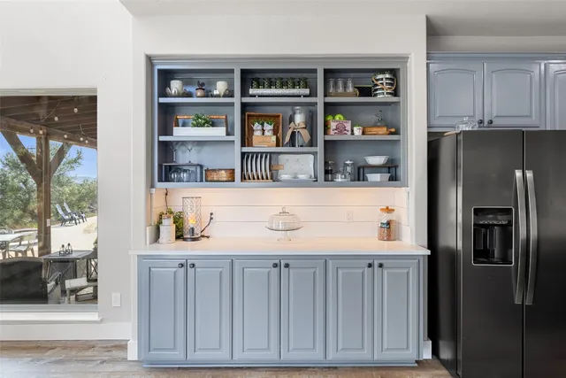 a kitchen with stainless steel appliances a refrigerator and a cabinets