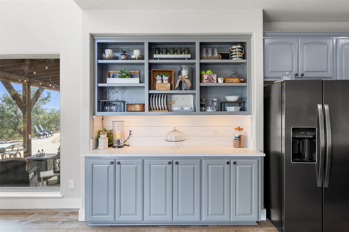 3108 Rolling Hills Road Blanco, TX 78606 - Photo 12 of 39 a kitchen with stainless steel appliances a refrigerator and a cabinets