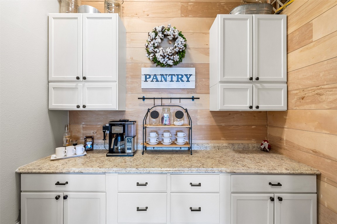 3108 Rolling Hills Road Blanco, TX 78606 - Photo 13 of 39 a kitchen with granite countertop white cabinets and a sink