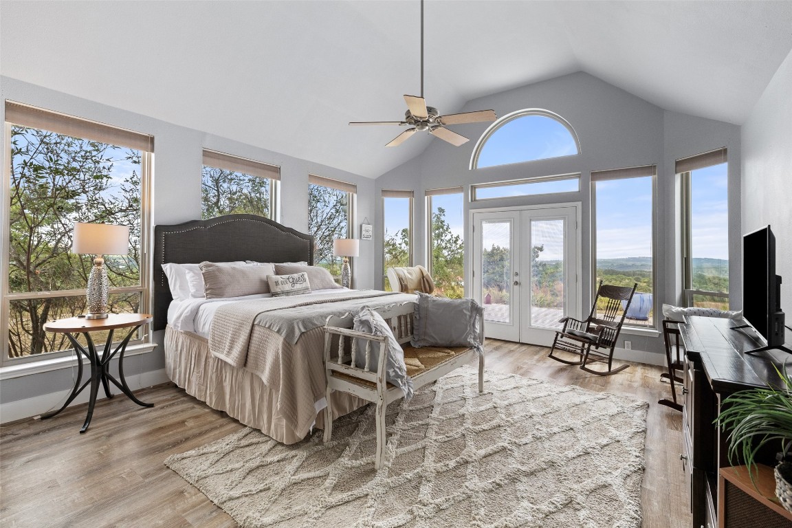 3108 Rolling Hills Road Blanco, TX 78606 - Photo 15 of 39 a bedroom with a bed and large windows