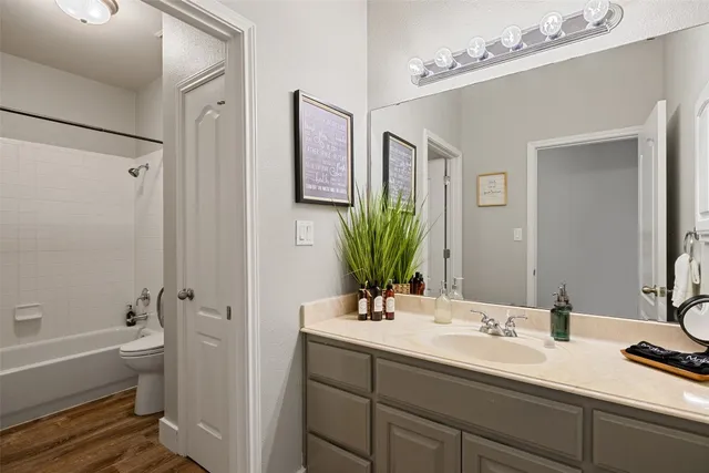 a bathroom with a tub sink and mirror