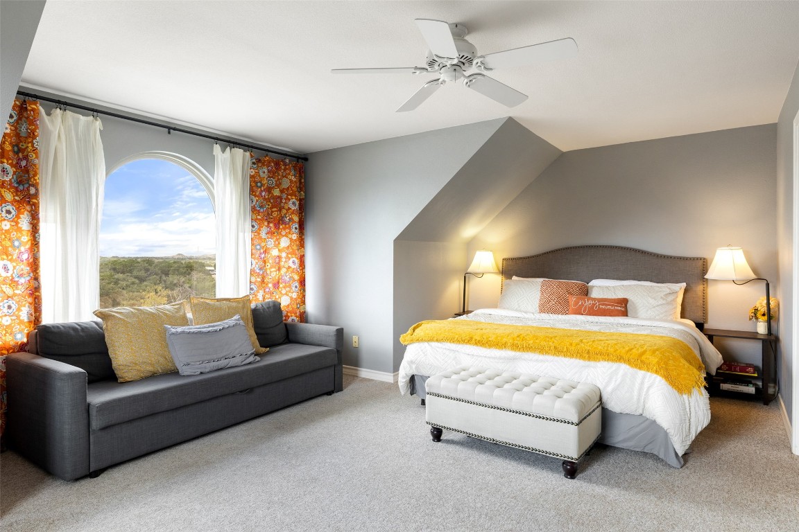 3108 Rolling Hills Road Blanco, TX 78606 - Photo 27 of 39 a bedroom with a bed and a couch with outer view