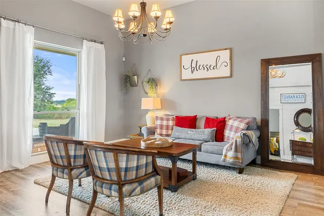 a living room with furniture and a chandelier