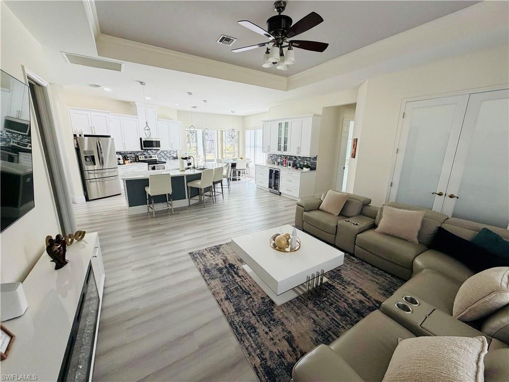 3960 1st Avenue Northwest Naples, FL 34119 - Photo 11 of 25 a living room with furniture and a view of kitchen