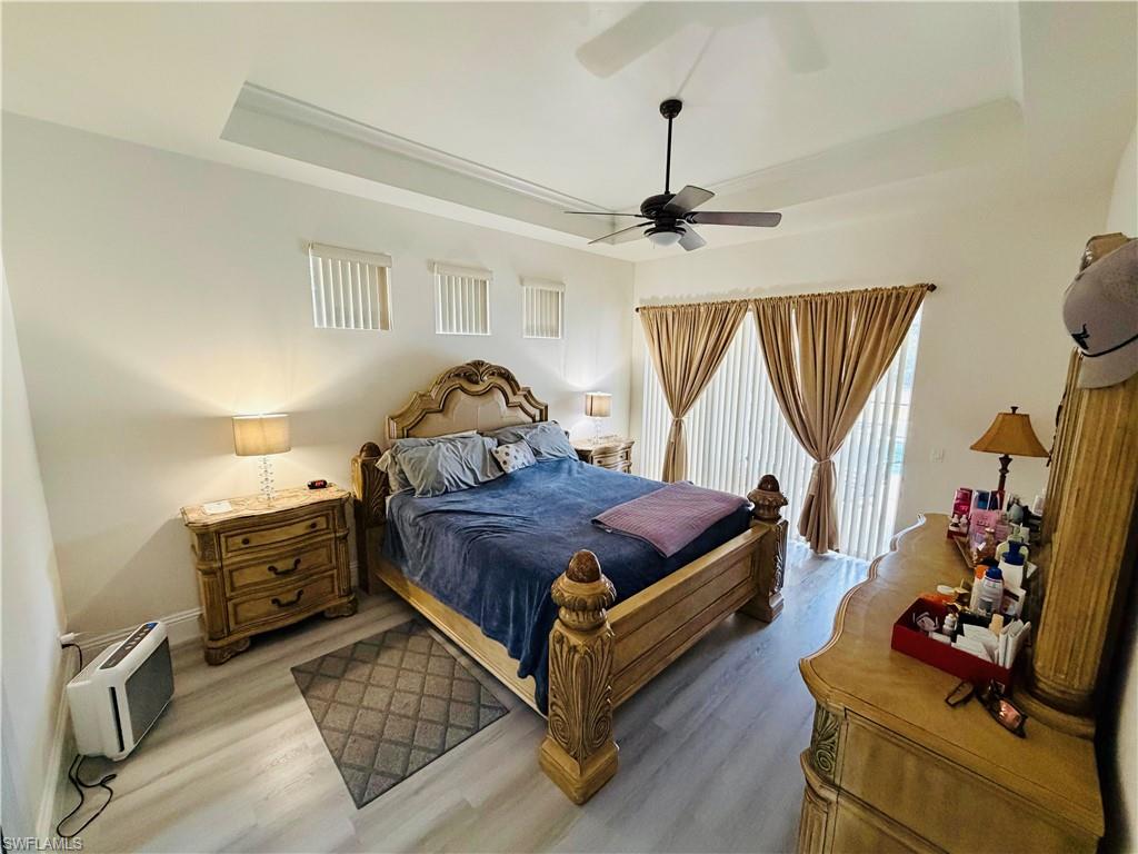 3960 1st Avenue Northwest Naples, FL 34119 - Photo 13 of 25 a bedroom with bed and wooden floor