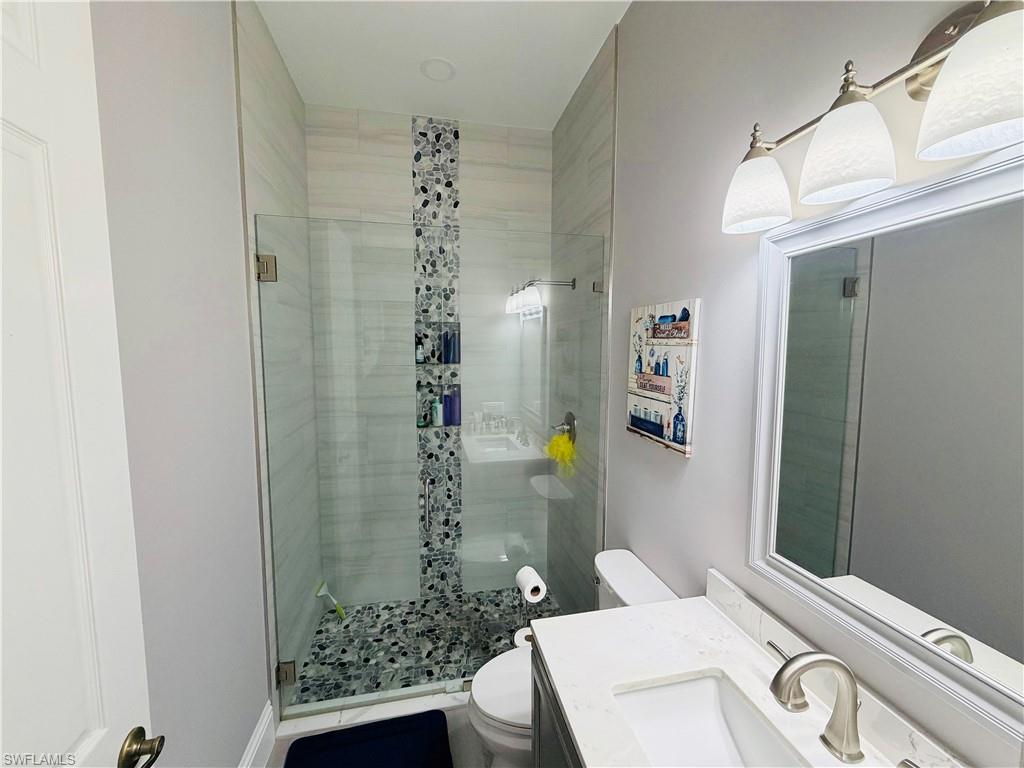 3960 1st Avenue Northwest Naples, FL 34119 - Photo 16 of 25 a bathroom with a sink a toilet and shower