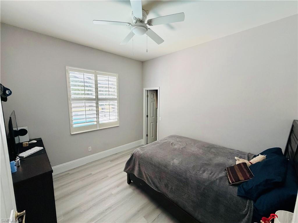 3960 1st Avenue Northwest Naples, FL 34119 - Photo 18 of 25 a bedroom with a bed and a closet