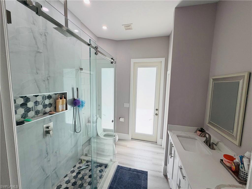 3960 1st Avenue Northwest Naples, FL 34119 - Photo 19 of 25 a bathroom with a sink a toilet and shower